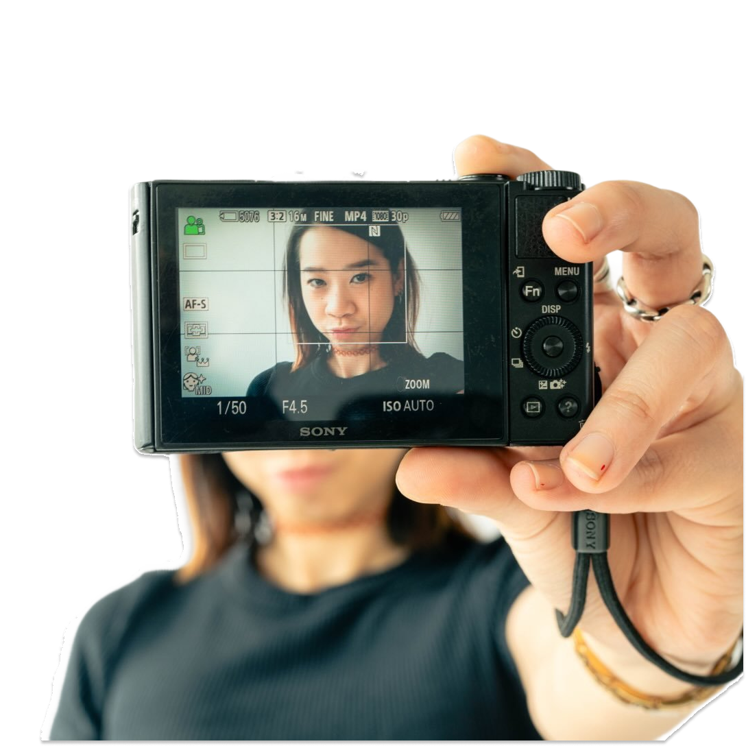 Portrait of Pei Chiao Lin holding a Sony camera up to her face